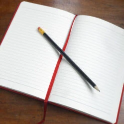 Personalised Personalised Notebook - Constructed Initial -Literary Gift Shop open notebook on table red